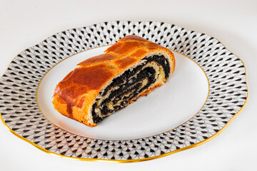 Traditional Hungarian poppy seed roll on an elegant Herend porcelain plate.