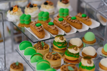 Close up view of candy bar serving with macarons and other delicious sweets on the festive table.