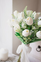 Bridal bouquet. A bouquet of white tulips and greens. White wedding bouquet.	