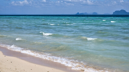 Beach, clouds and waves on the sea / ocean