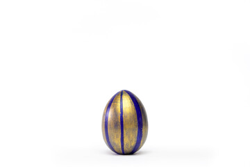 Happy Easter. One easter egg trendy colored classic blue, white and golden on white. Copy space. Minimal style