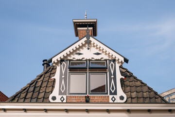 Nice window decoration on the top floor of a house in Friesland, Netherlands