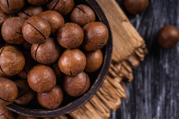 Macadamia nuts are cracked and baked to taste extremely delicious. Toasted organic healthy food.