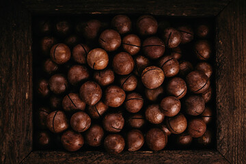 Macadamia nuts are cracked and baked to taste extremely delicious. Toasted organic healthy food.