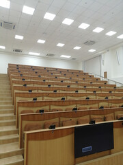 Fototapeta premium empty lecture room for students. lecture classroom, rows of empty wooden desks and seats