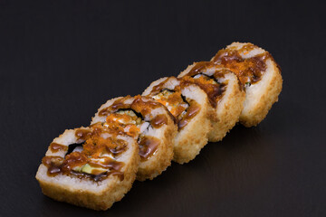 Sushi Rolls Ebi Tempura Maki with RICE, TIGER SHRIMPS, CREAM CHEESE, AVOCADO, CUCUMBER, MASAGO and TERIJAKI sauce
