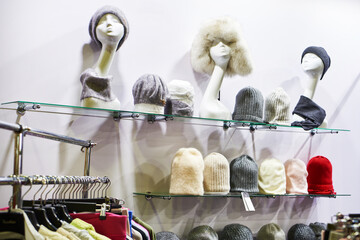 Woolen hats on heads of mannequins in store