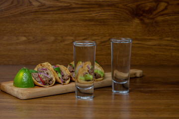 Mexican tacos with guacamole, onion and shot of tequila. Mexican food
