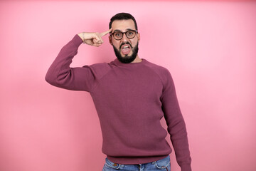 Handsome man wearing glasses and casual clothes over pink background having an idea