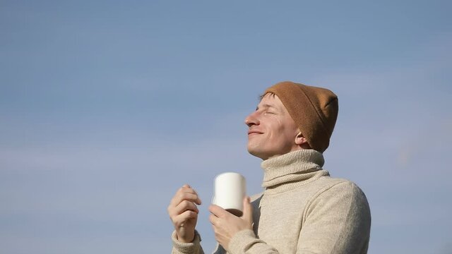 Man tea cup. Sensual. Sky background. Video. Good morning. 