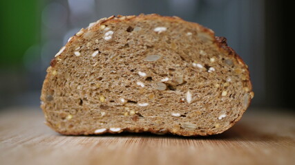 Slicing Whole Grain Bread On Wooden Table.