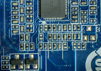Close-up of microcircuits and boards on blue motherboard in personal computer