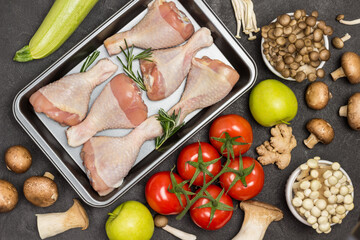 Chicken drumsticks in metal baking pallet