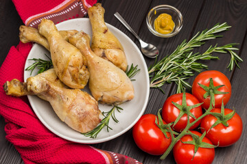 Chicken meat on ceramic plate. Red napkin on table