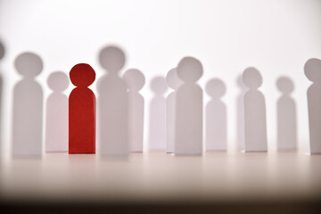 Social discrimination many paper men and a different one front