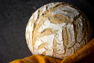 Sourdough bread texture close up. Crusty bread with beautiful pattern on the top. Healthy eating concept. 