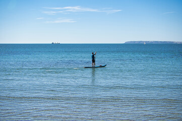 paddle surfing on the beach, located in Alicante, Spain.
