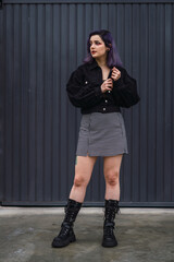 Portrait of a young woman with purple hair posing 