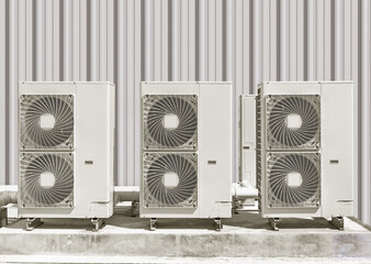 Condenser unit or compressor outside industrial plant building. Unit of central air conditioner...
