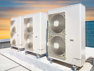 Condenser unit or compressor on roof of industrial plant building with sky background. Unit of...