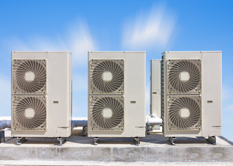Condenser unit or compressor on roof of industrial plant building with sky background. Unit of...