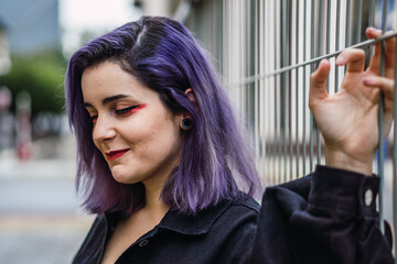 Portrait of a young woman with purple hair posing 