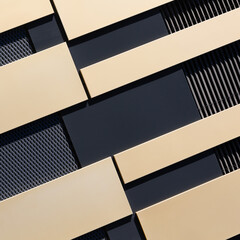Modern, abstract house facade with black and gold-coloured elements in sqaire format, as background for architecture