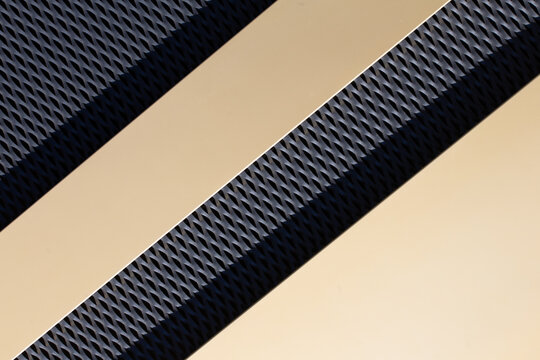 Abstract house facade with black and gold surfaces with sun reflection as background for architecture or art topics