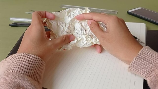 opening a wrapped up paper in the workplace