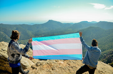 Two Men Showing Transgender Flag Blue and Pink on the Top of a Mountain (LGTB rights)