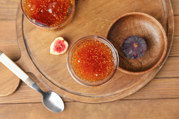 Jar of sweet fig jam on wooden table