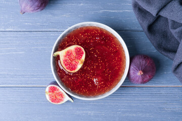 Bowl of sweet fig jam on wooden table