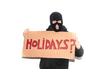 Thief wearing a ski mask showing a cardboard sign on which the word 