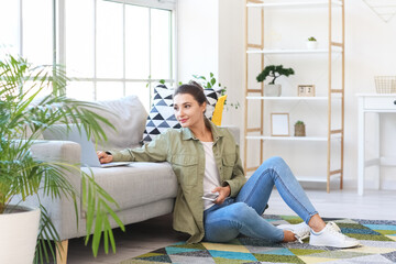 Fototapeta premium Young woman with laptop at home