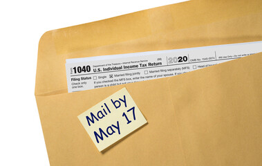 Printed copy of Form 1040 for income tax return for 2020 with reminder for May 17 2021 deadline