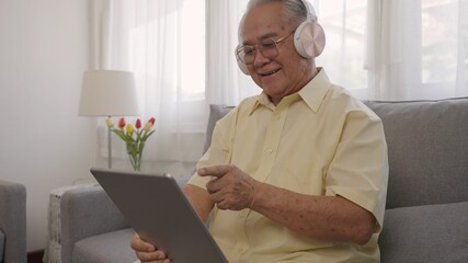 Asian older man patient having video conference with family on computer pc at home. Senior holidays,Technology,People,Retirement,Lifestyle,Global,Education,Family concept,Holiday. Senior Technology
