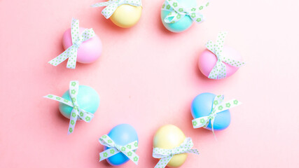 Fototapeta na wymiar Easter background. Colorful egg with tape ribbon on pastel pink background in Happy Easter decoration. Spring holiday top view concept.