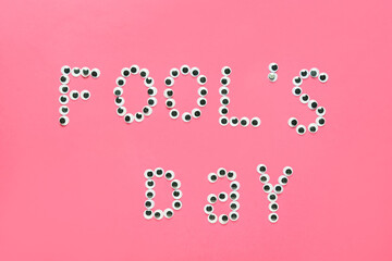 Text FOOL'S DAY on color background