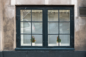 Small Christmas decorations in the window of an old tenement house