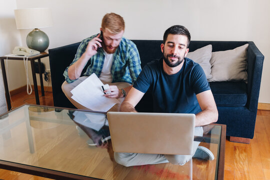 Workaholic Male Couple Working At Home