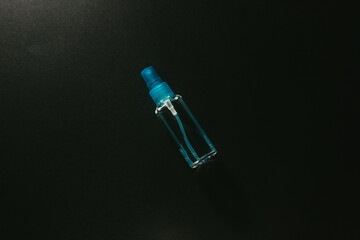 Small spray bottle on black background