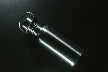 Metal water bottle on a black bacground
