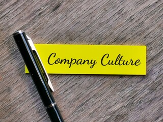 Business concept. Phrase COMPANY CULTURE written on sticky note with a pen isolated on wooden background.