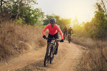 Group of Asian cyclists, they cycle through rural and forest roads.