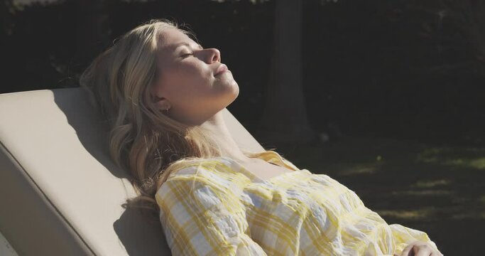 Gorgeous Lady in Yellow Dress Sunbathing from Her Backyard Garden