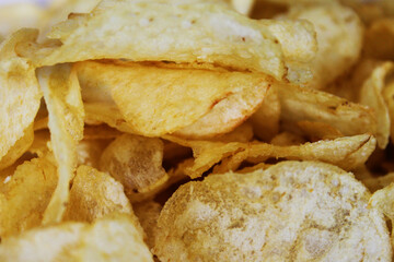 Close-up of a pile of plain potato chips.