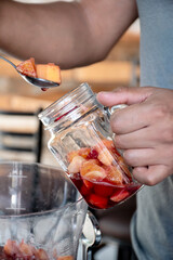 Serving clericot alcoholic drink in glass with cold drink with ice and red fruit