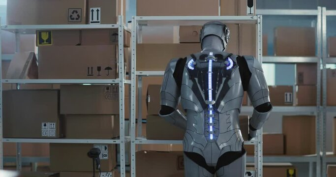 Future is now. Cybernetic futuristic robot employee working inside post office workshop carrying heavy delivery boxes doing human job alone. Services. Robotic science.