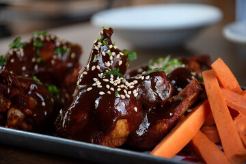 wings in hot sauce served with carrot garnish