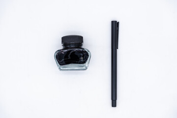 A pen and a bottle of ink